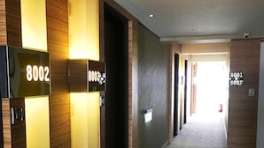 A hallway with illuminated room numbers 8002, 8003, 8001, and 8007. - Century Hotel Taoyuan (Taoyuan City)