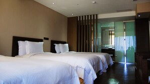 A hotel room with two beds, a wooden headboard, a mirror, and a sliding door leading to a bathroom. - Century Hotel Taoyuan (Taoyuan City)