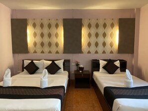 A hotel room with two beds, each with a headboard, a nightstand, and a wall-mounted light fixture. - Khaolak Grand City (Takua Pa)