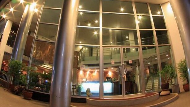 A modern building with large glass windows and a central entrance. - NEO Hatyai Hotel (Hat Yai)