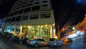 A multi-story hotel with a modern facade, large windows, and a covered entrance area. - NEO Hatyai Hotel (Hat Yai)
