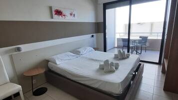 خزنة داخل الغرفة ومكتب وملاءات أسرّة