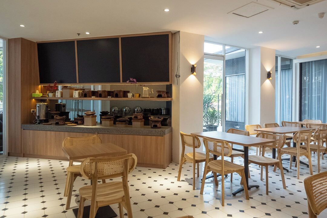 A modern dining area with wooden furniture and a central counter.