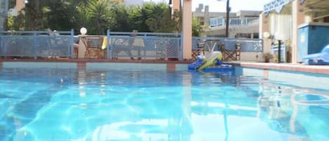 Seasonal outdoor pool, pool umbrellas, pool loungers