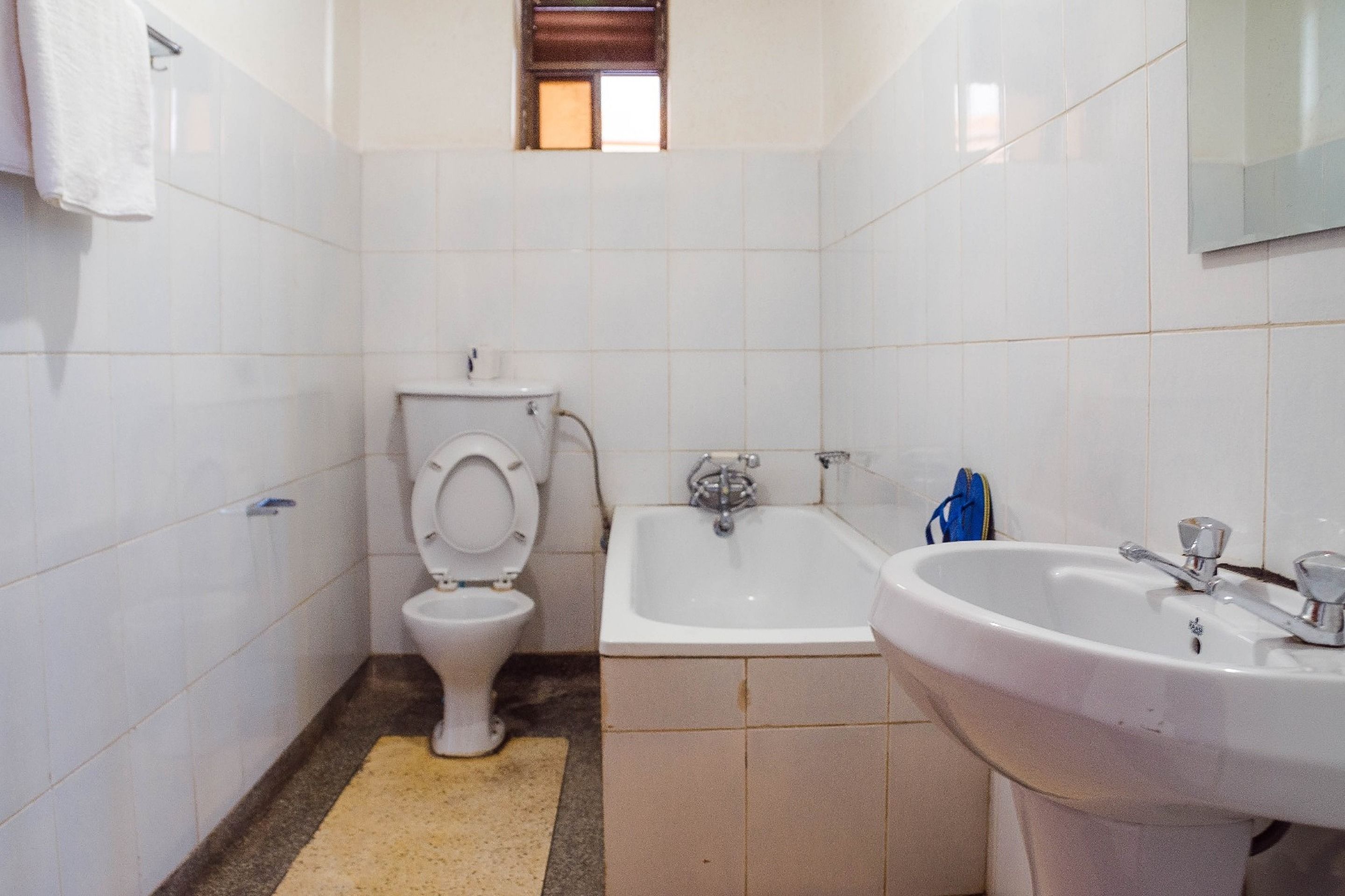A bathroom with a toilet, a sink, and a bathtub.