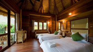 A wooden cabin with two beds, a desk, and a large window. - Keeree Waree Seaside Villa (Bang Saphan)