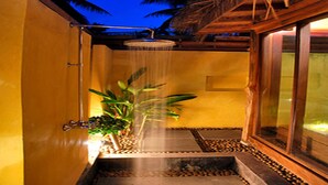 A shower area with a rain showerhead, a potted plant, and a tiled floor. - Keeree Waree Seaside Villa (Bang Saphan)