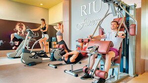 A gym with various exercise equipment, including treadmills and weight machines.