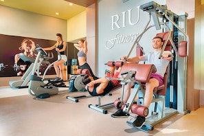 A gym with various exercise equipment, including treadmills and weight machines. - Alua Helios Bay (Nessebar)