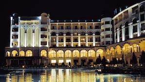 A large hotel with multiple balconies and a pool area. - Alua Helios Bay (Nessebar)