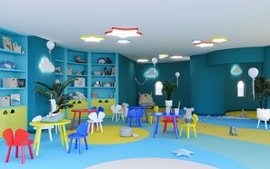 A colorful children's playroom with various toys, chairs, and a bookshelf. - Alua Helios Bay (Nessebar)