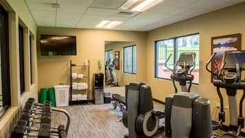 A gym with treadmills, elliptical machines, and weight machines.