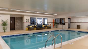 Relax by the pool, surrounded by a comfortable seating area and safety features.
