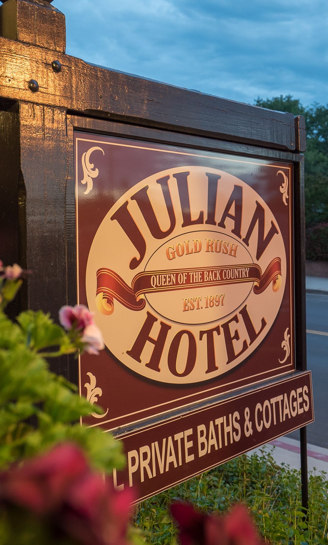 A sign for Julian Gold Rush Hotel, established in 1891, advertising private baths and cottages.