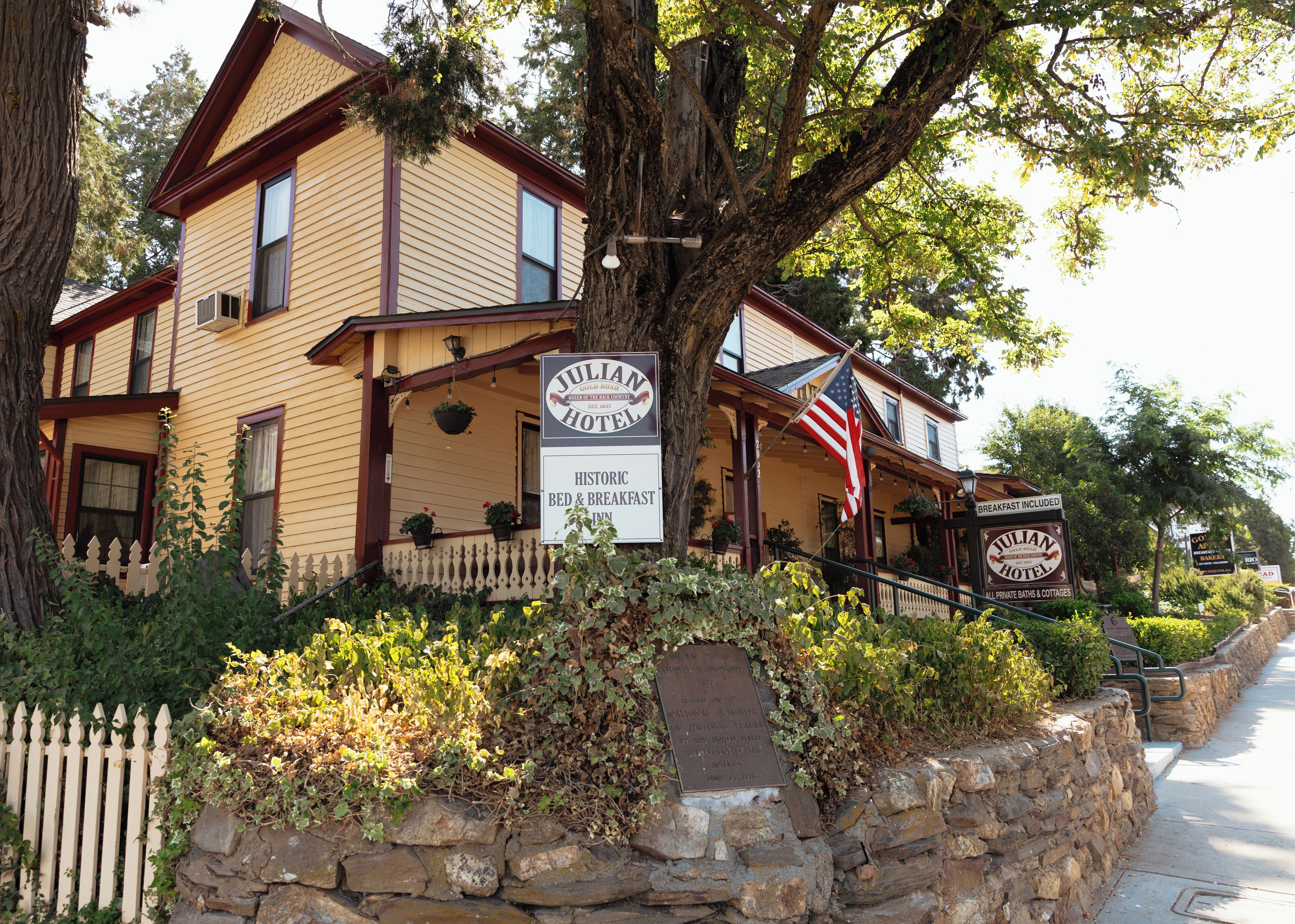 A historic Julian Hotel with a sign indicating it offers breakfast.