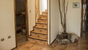 A staircase with wooden steps and a modern light fixture above it.