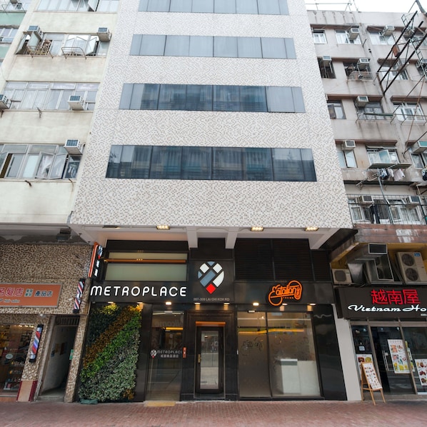 A multi-story building with a storefront labeled "METROPLACE" and a sign for "Vietnam House". - METROPLACE BOUTIQUE (Kowloon)