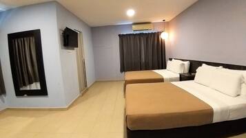 A hotel room with two beds, a flat-screen TV, an air conditioner, and a ceiling light.