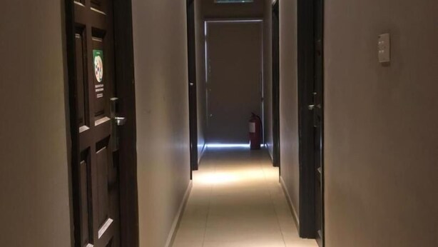 A long, well-lit hallway with doors on both sides, leading to a sign that reads "KELUAR". - Hotel Jelai Mentakab (Mentakab)