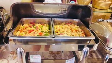 A buffet with pasta dishes and a sign indicating 'NINH KIEU 2'.