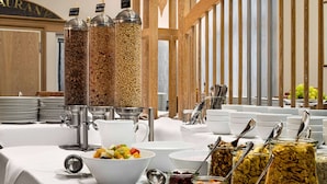 A buffet setup with various food containers and utensils. - Amedia Weiden, Trademark Collection by Wyndham (Weiden in der Oberpfalz)