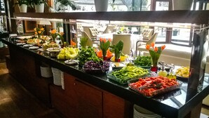 A buffet with various food items and a seating area in the background. - Paradise Island Hotel (Darica)