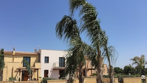 A two-story building with a flat roof, satellite dishes, and a balcony. - Herons Bay Resort (Marsala)
