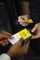 A person holding a hotel key card with the name "allstay" visible.