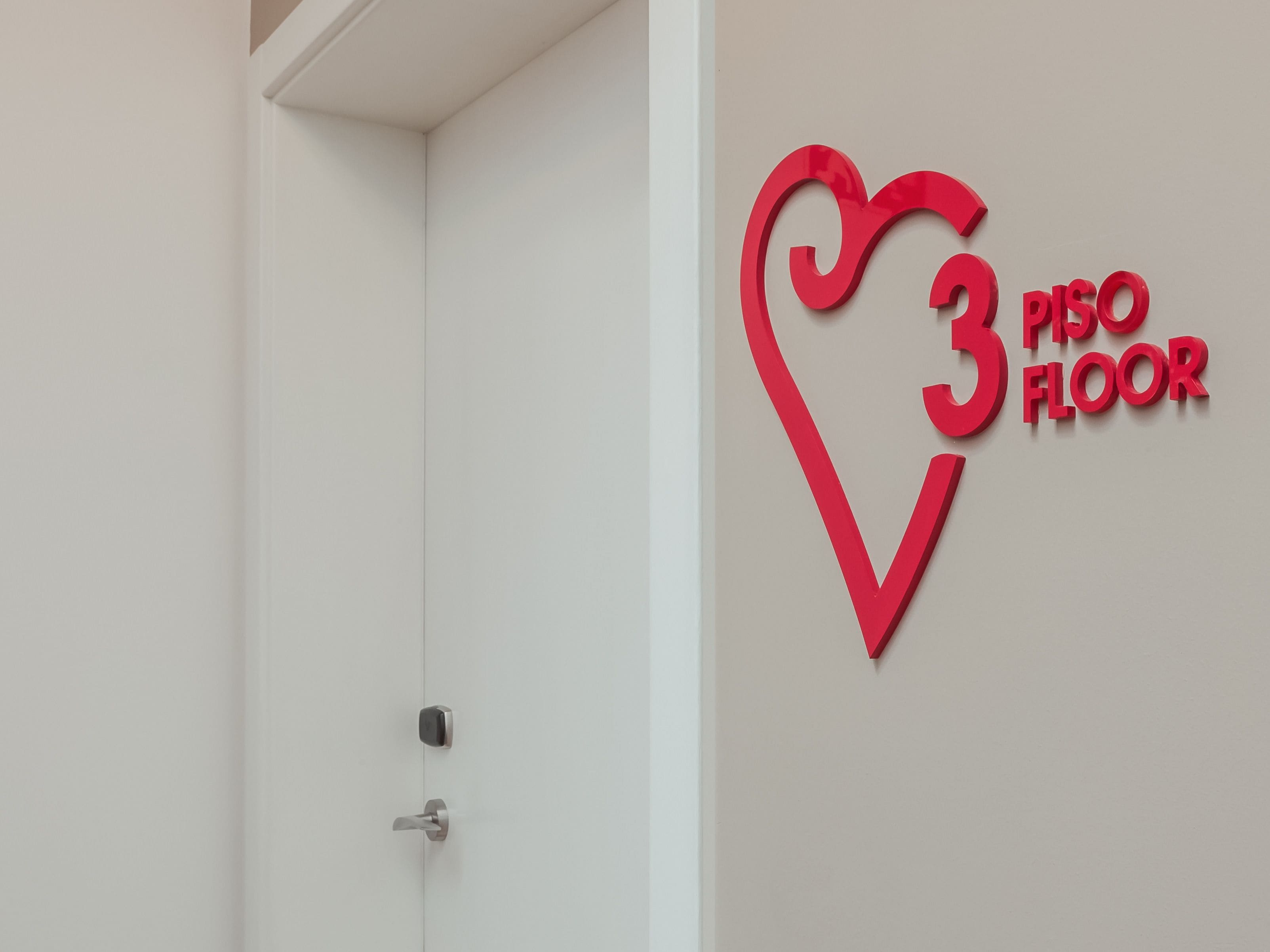 Una puerta con un picaporte moderno y un letrero en la pared que indica el tercer piso.