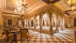 A luxurious room with ornate ceiling, checkered floor, and traditional furniture. - BrijRama Palace, Varanasi - By the Ganges (Varanasi)