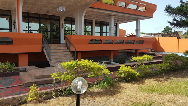 A two-story building with a staircase leading to the upper level. - Tribeca Hotel Annex (Koforidua)