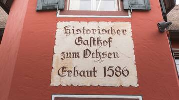 A building facade with a historical plaque.