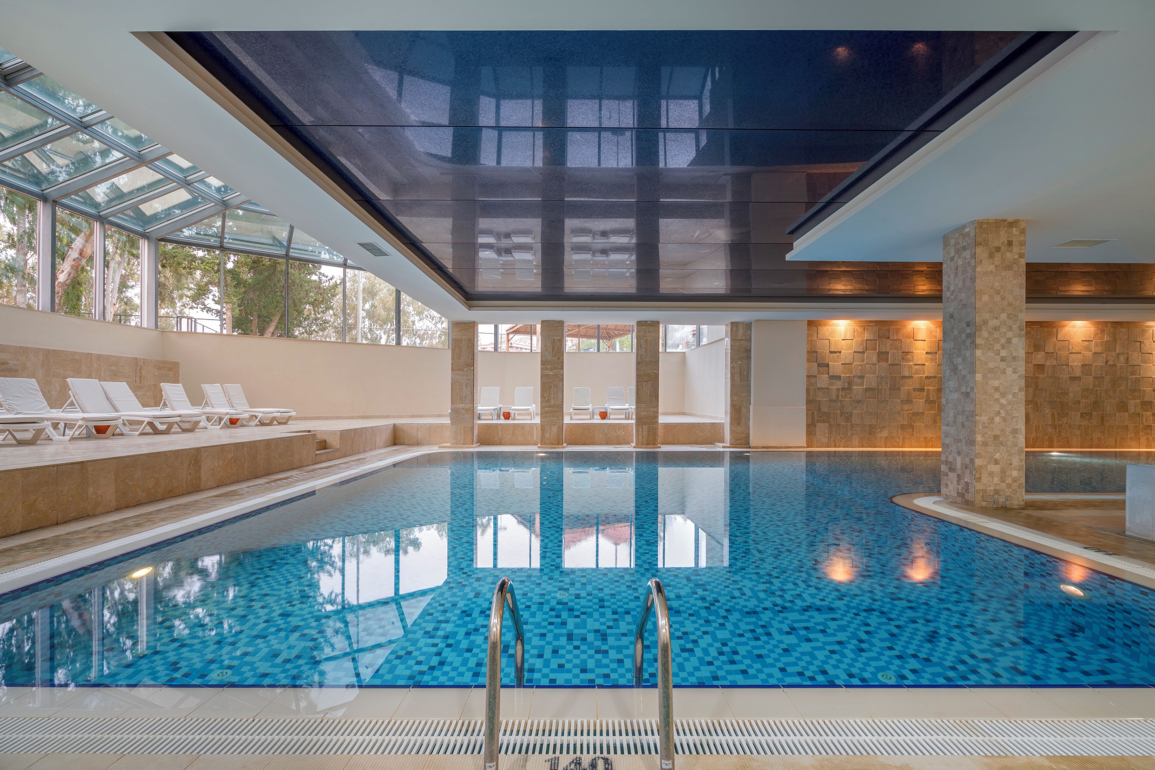 Indoor pool, seasonal outdoor pool, pool umbrellas, pool loungers