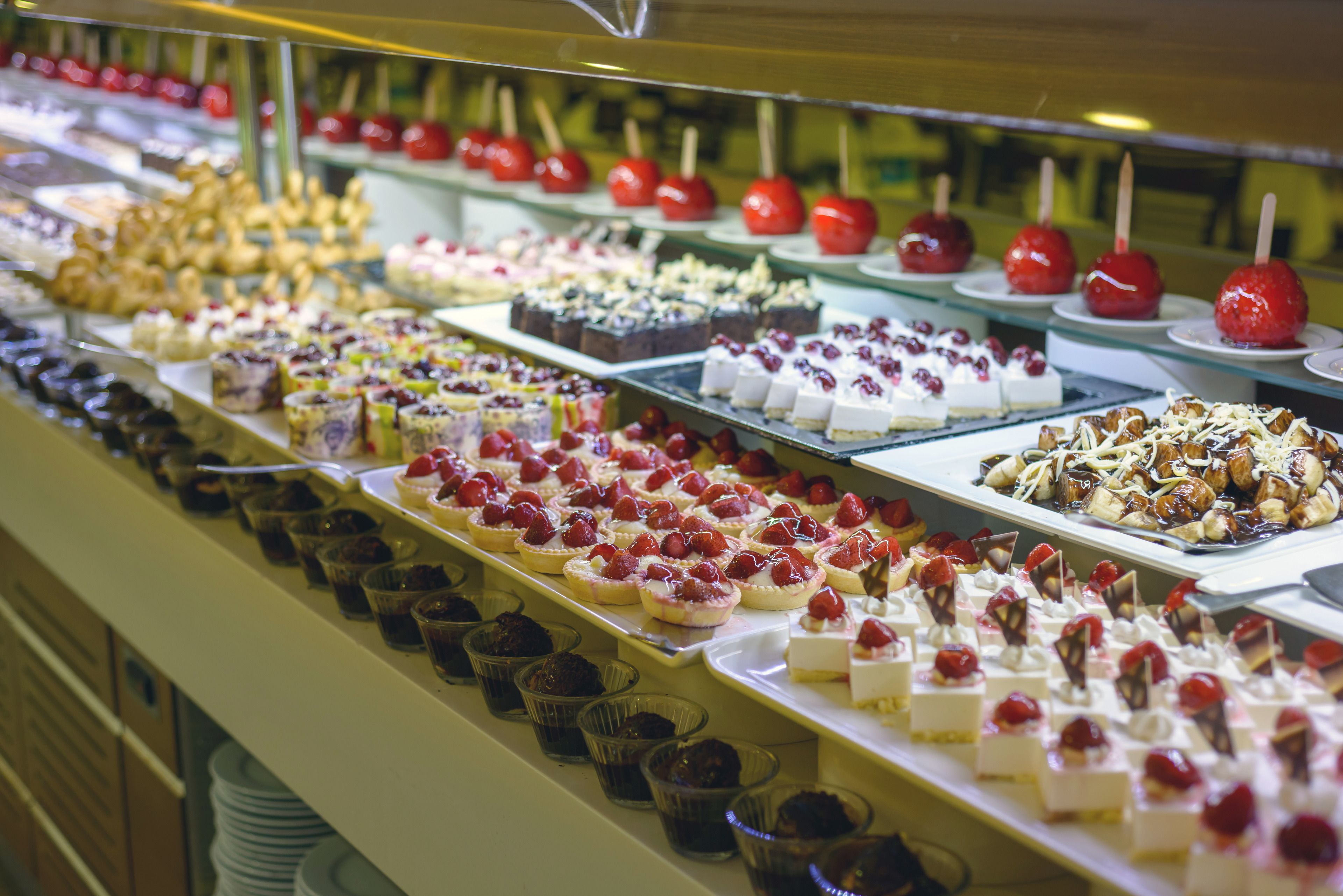 A variety of desserts displayed on a buffet table.