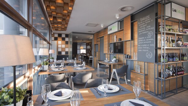 A modern restaurant with wooden tables and chairs, a chalkboard menu, and a bar area with bottles.