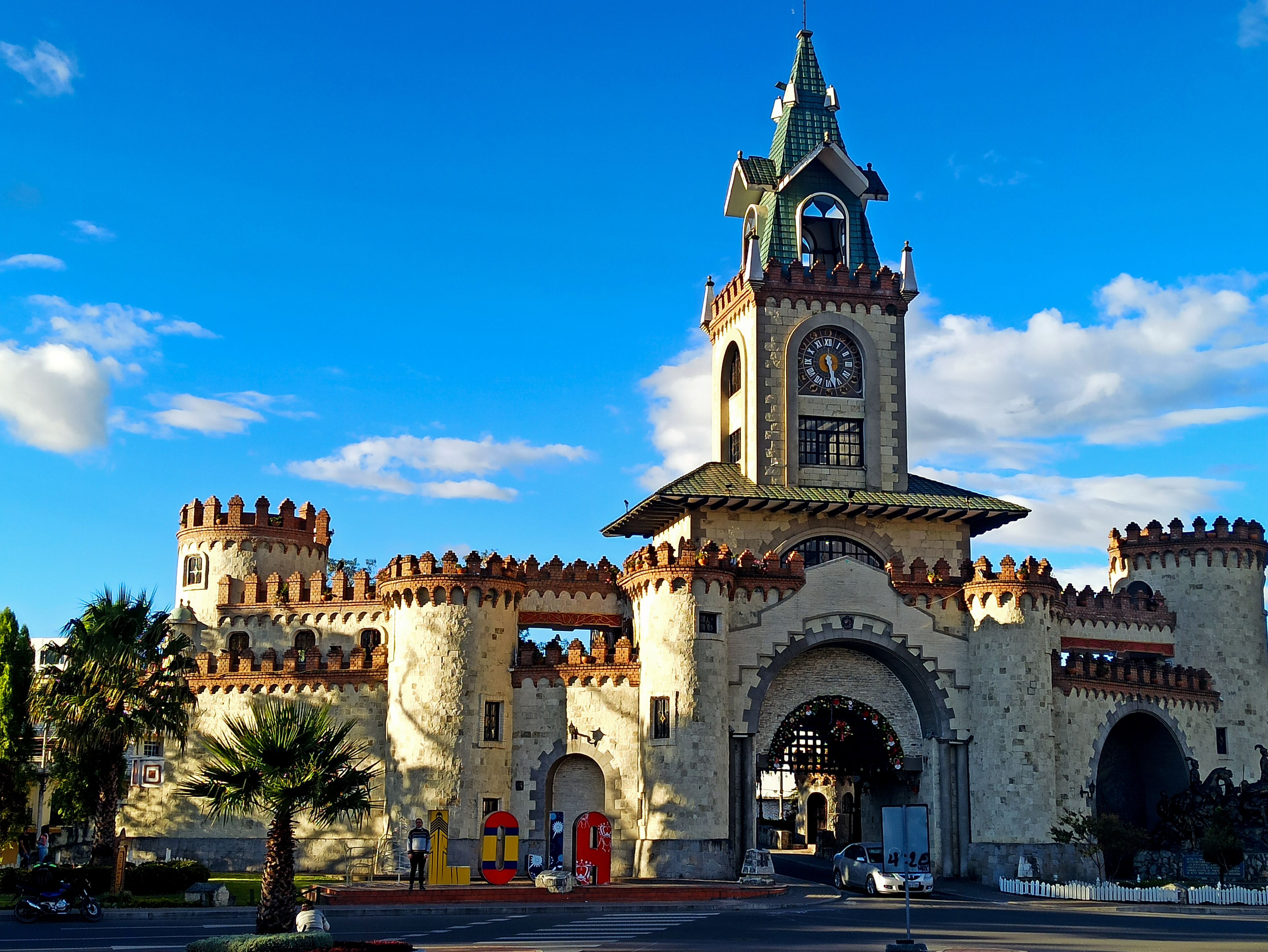 A historic building with a clock tower, arched entrance, and decorative towers.