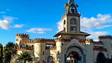 A historic building with a clock tower, arched entrance, and decorative towers.