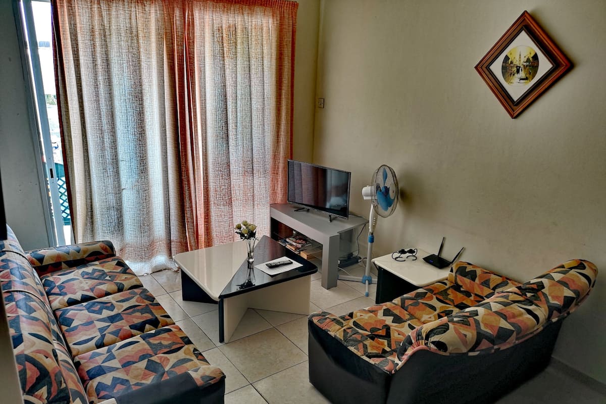 Apartment, 1 Bedroom, Balcony, Garden View | Living area | Flat-screen TV