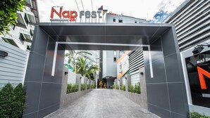 A modern building entrance with a sign reading "Napfest." - Nap in Fest (Chiang Mai)