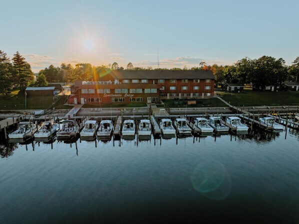 A marina with boats docked in front of a building labeled "Sportsmans Lodge." - Sportsman's Lodge (Baudette)