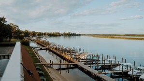 A marina with docked boats and a wooden pier extending into calm water. - Sportsman's Lodge (Baudette)