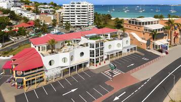 A coastal hotel with a red-roofed building, a market garden, and a casino.