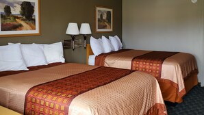 A hotel room with two beds, a desk, two lamps, and two paintings on the wall. - Budget Inn Express Douglas (Douglas)
