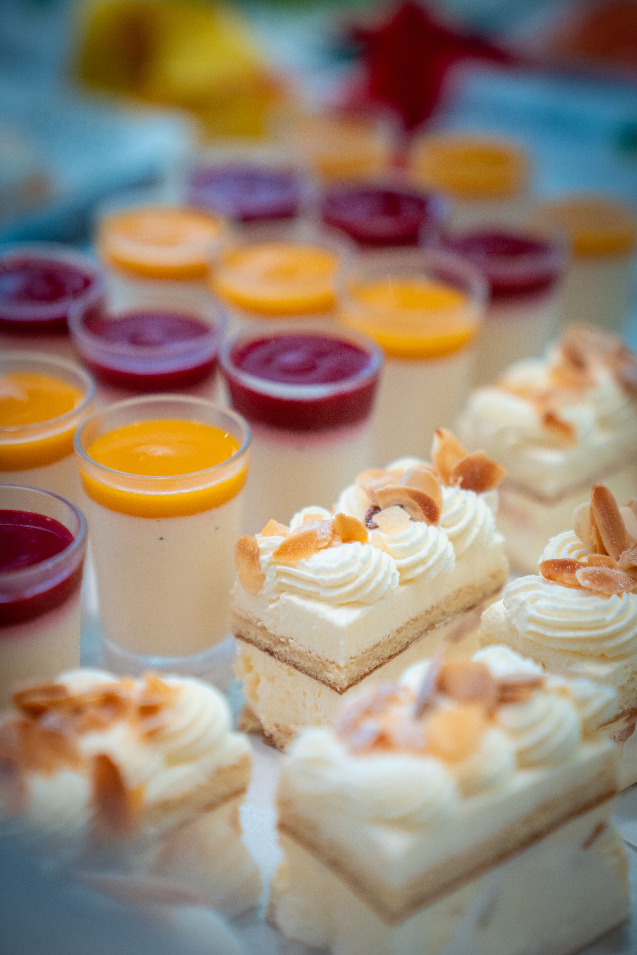 A variety of desserts including cakes and fruit tarts on a table.