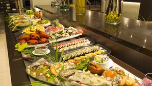 A buffet with various seafood and sushi dishes.