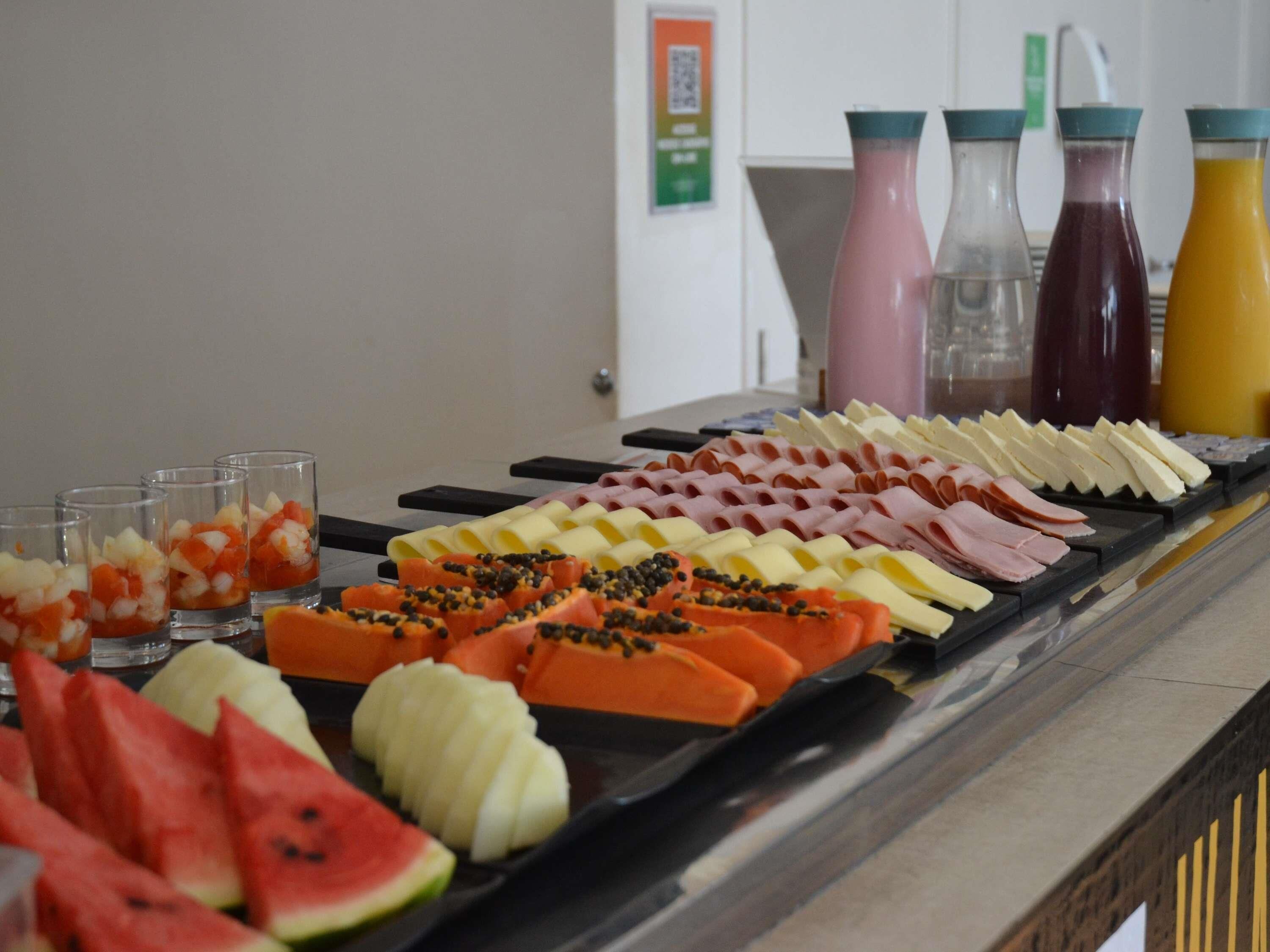 A buffet with various food items and beverages.