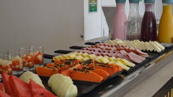 A buffet with various food items and beverages.