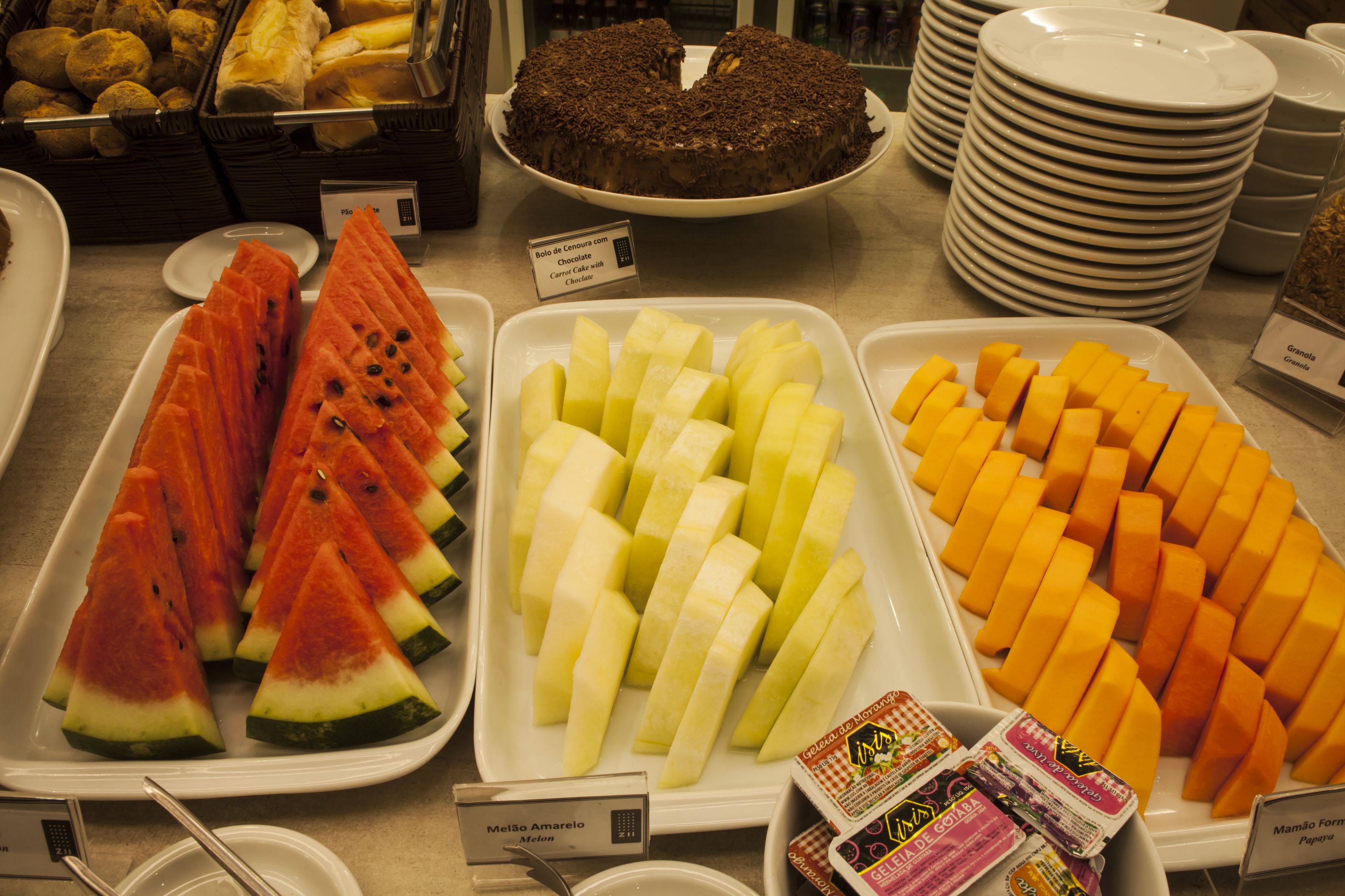 A buffet with various fruits and desserts.