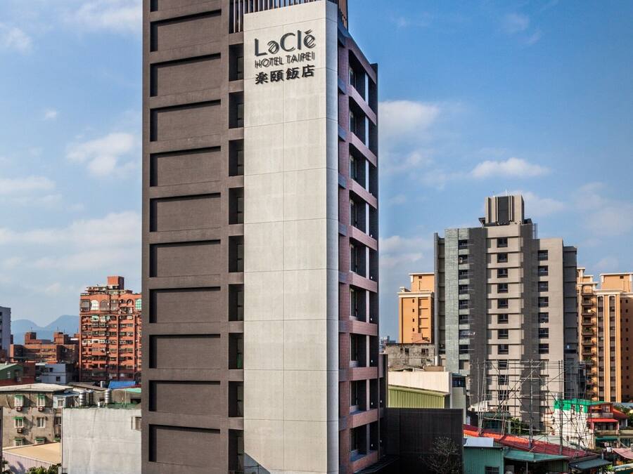 A modern hotel building with a prominent sign for "LoClé Hotel Taipei".
