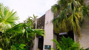 A building with a brick facade, an 'ENTRY' sign, and a sign indicating an 'EXPORT' area.
